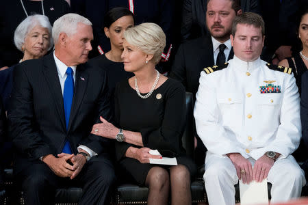 Cindy McCain, wife of, Sen. John McCain, R-Ariz., right, talks with Vice President Mike Pence, left, after he speaks at a ceremony for John McCain as he lies in state in the Rotunda of the U.S. Capitol, Friday, Aug. 31, 2018, in Washington. Also pictured is McCain's son Navy Lt. Jack McCain, right. Andrew Harnik/POOL Via REUTERS