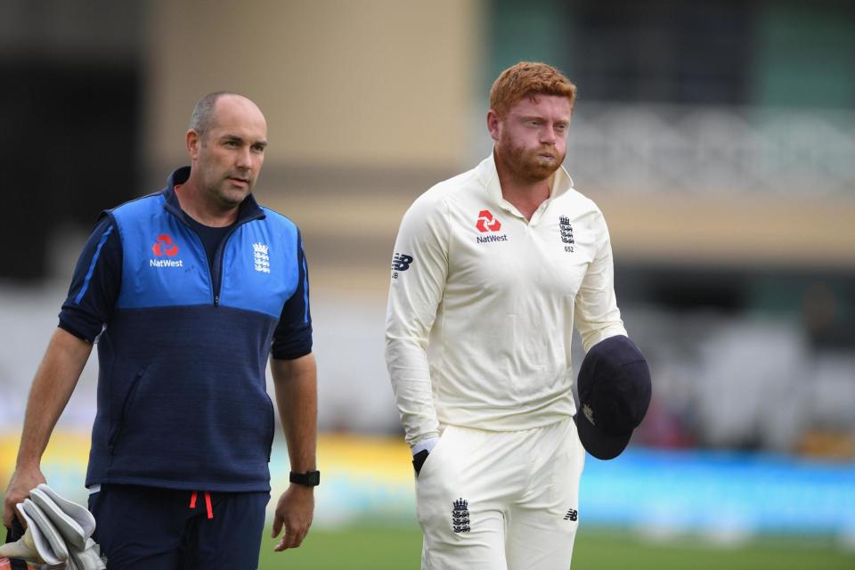 Hand in cap: Jonny Bairstow covers up his broken middle finger as leaves the field yesterday but it could mean he will be able to concentrate on his destructive batting: Getty Images