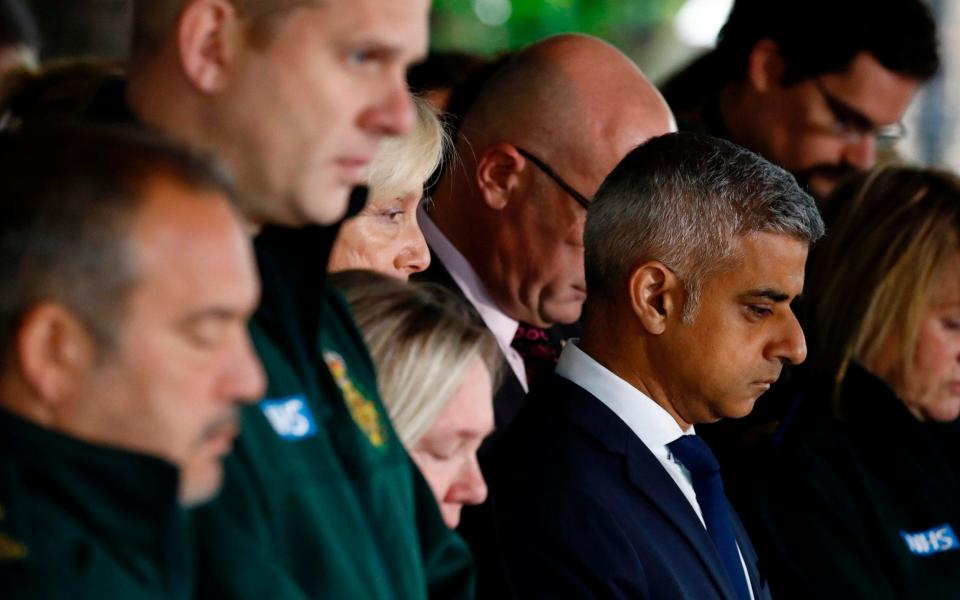 Mayor of London Sadiq Khan stands with ambulance paramedics as they pause for a minutes' silence - Credit: ODD ANDERSEN/AFP/Getty Images