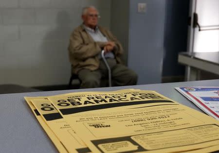 A man sits at a health insurance enrollment event in Cudahy, California March 27, 2014. REUTERS/Lucy Nicholson