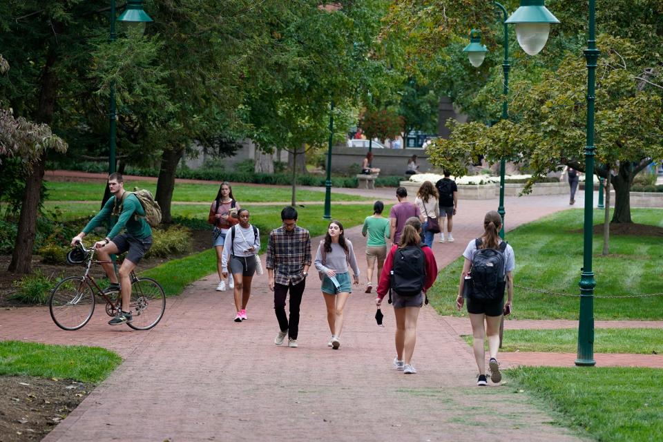 Students walk to and from classes on the Indiana University campus on Oct. 14, 2021.