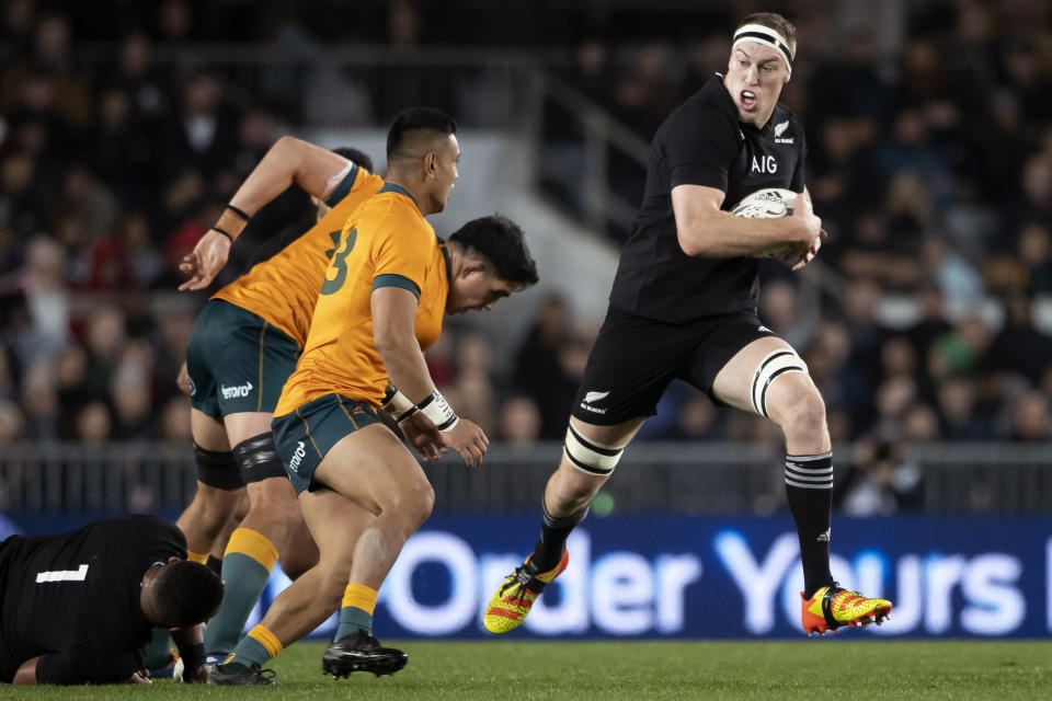New Zealand's Brodie Retallick, right, runs past Australian defenders during their Bledisloe Cup rugby union test match at Eden Park in Auckland, New Zealand, Saturday, Aug. 7, 2021. (Brett Phibbs/Photosport via AP)