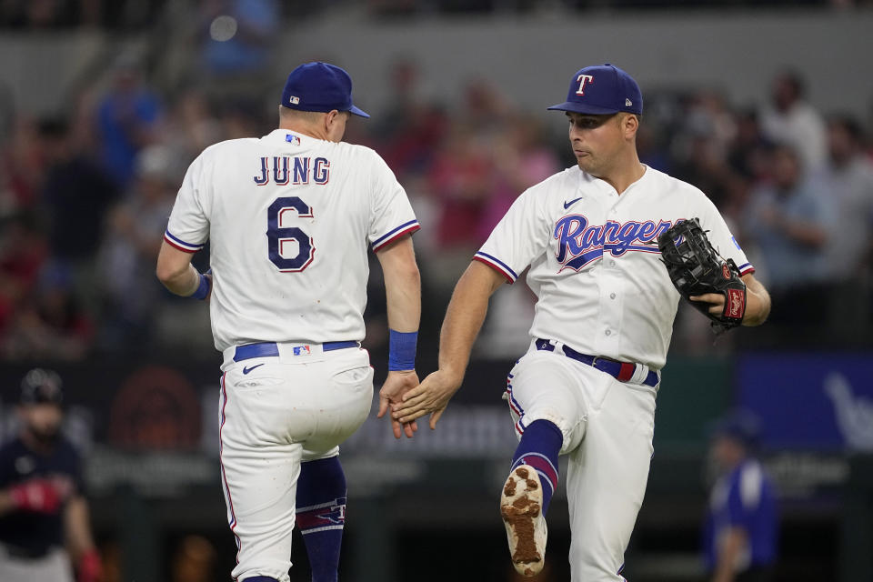 Texas Rangers' Josh Jung (6) and Nathaniel Lowe, right, celebrate their team's 15-5 win in a baseball game against the Boston Red Sox, Wednesday, Sept. 20, 2023, in Arlington, Texas. (AP Photo/Tony Gutierrez)