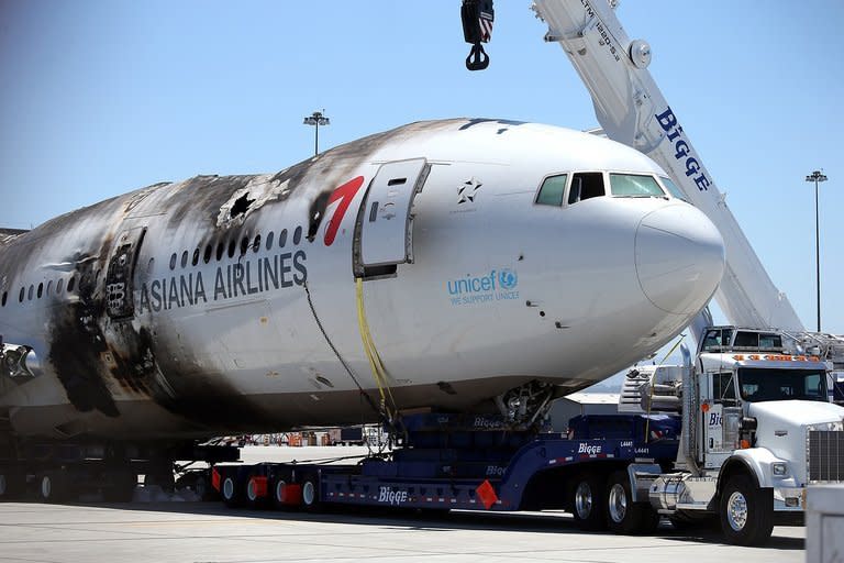 The wrecked fuselage of Asiana Airlines flight 214 sits in a storage area at San Francisco International Airport on July 12, 2013 in San Francisco, California. A third girl, reportedly Chinese, died of injuries sustained in the Asiana jet crash in San Francisco, as authorities confirmed that a firetruck ran over one of the other victims