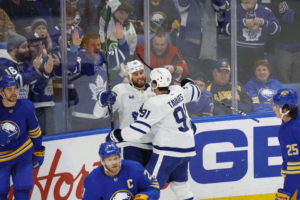 Toronto Maple Leafs center Ryan O'Reilly (90) celebrates his third with center John Tavares (91) during the third period of an NHL hockey game against the Buffalo Sabres, Tuesday, Feb. 21, 2023, in Buffalo, N.Y. (AP Photo/Jeffrey T. Barnes)