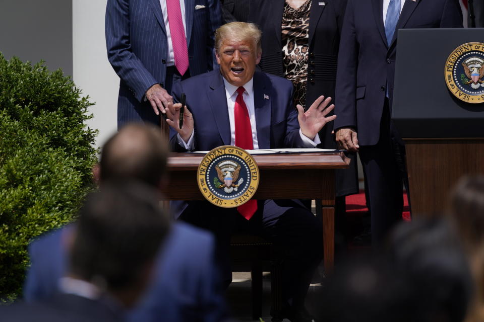 President Donald Trump speaks as he signs the Paycheck Protection Program Flexibility Act during a news conference in the Rose Garden of the White House, Friday, June 5, 2020, in Washington. (AP Photo/Evan Vucci)