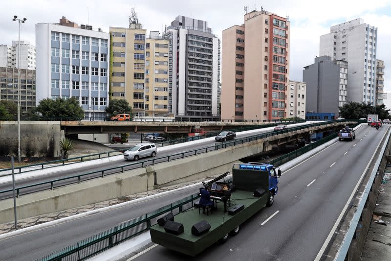 Pianist Rodrigo Cunha serenades from an open truck, in Sao Paulo