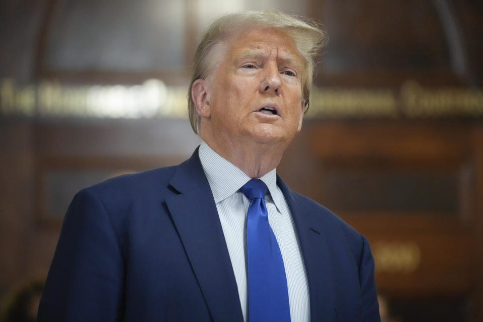 Former President Donald Trump speaks before returning to the courtroom after a break in his civil business fraud trial at New York Supreme Court, Wednesday, Oct. 25, 2023, in New York. The judge in Donald Trump's civil fraud trial has fined the former president $10,000. The judge says Trump violated a limited gag order barring personal attacks on court staffers.(AP Photo/Seth Wenig)