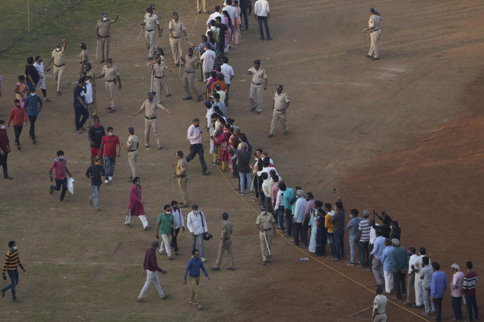 People line up to pay last respect to Lata Mangeshkar in Mumbai, India, Sunday, Feb.6, 2022. The legendary Indian singer with a prolific, groundbreaking catalog and a voice recognized by a billion people in South Asia, died Sunday morning of multiple organ failure. She was 92. (AP Photo/Rafiq Maqbool)