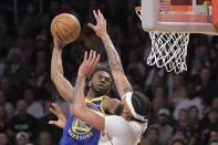 Golden State Warriors forward Andrew Wiggins, left, shoots as Los Angeles Lakers forward Anthony Davis defends during the second half in Game 3 of an NBA basketball Western Conference semifinal Saturday, May 6, 2023, in Los Angeles. (AP Photo/Mark J. Terrill)
