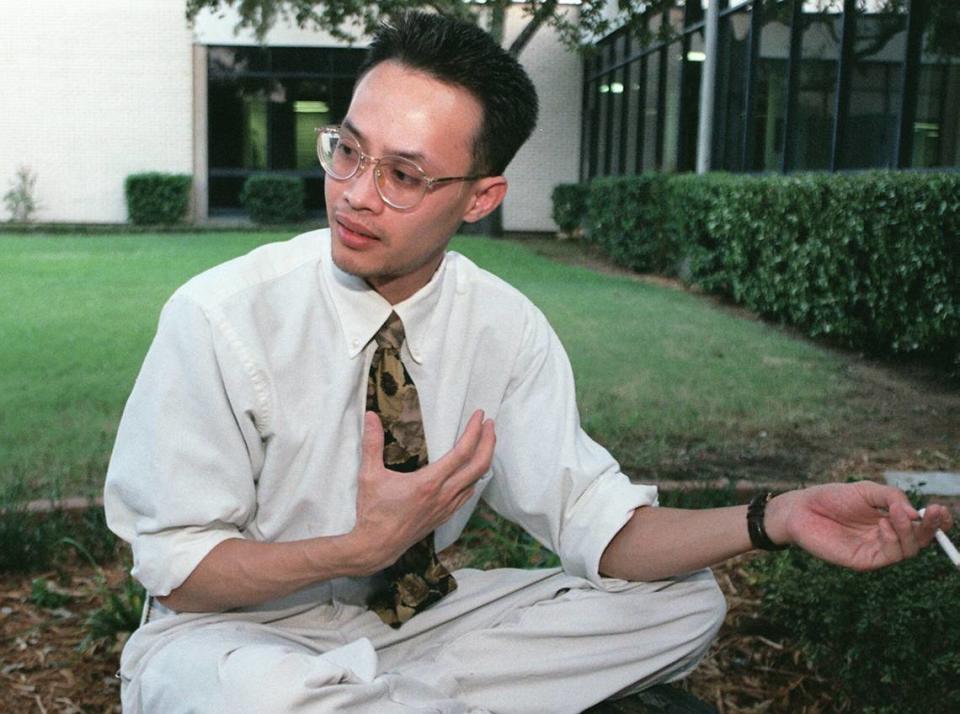 ARL ASLAY THANG KHUU---Thang Khuu talks with a reporter in the courtyard of the Arlington Star Telegram in 1996.