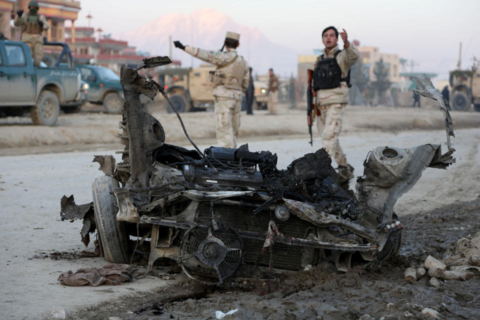 Afghan security forces arrive at the site where a suicide attacker rammed a car bomb into a NATO convoy killing two foreign civilian contractors, in the Afghan capital Kabul, Afghanistan, Monday, Feb. 10, 2014. The Islamic militant group Hizb-i-Islami claimed responsibility for the Monday attack in eastern Kabul, saying it would drive all foreign forces from Afghanistan. (AP Photo/Rahmat Gul)