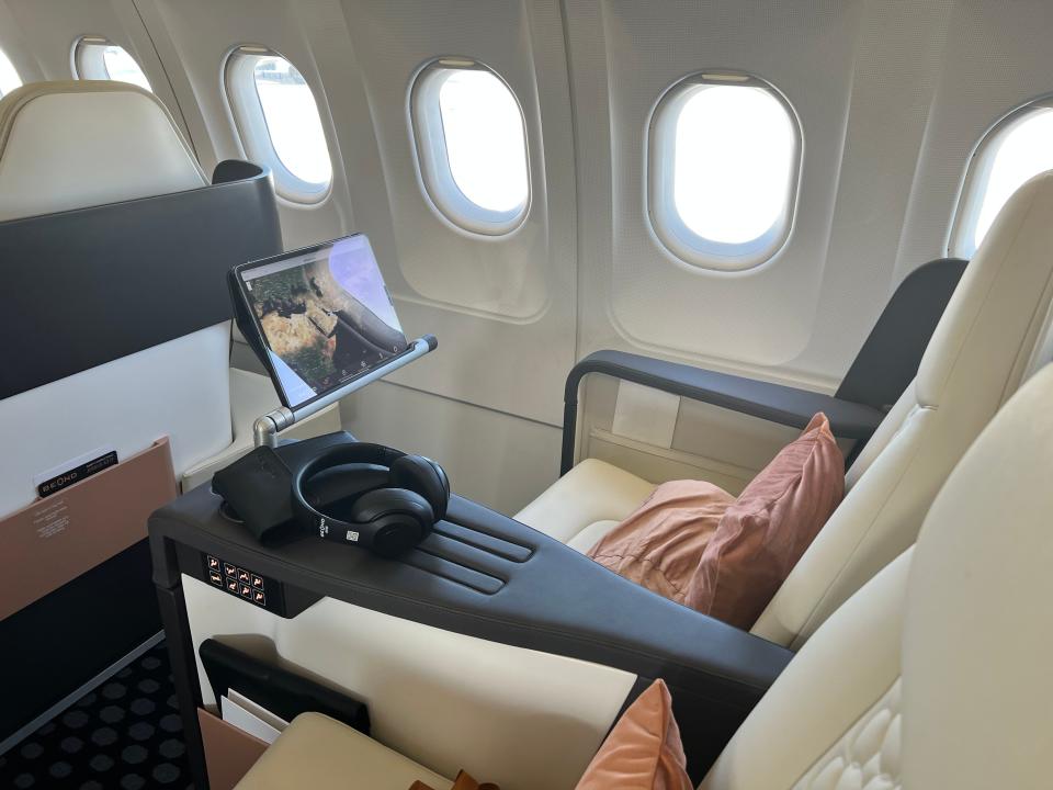 an iPad extending out from a seat on the Beond airliner at the Dubai Air Show