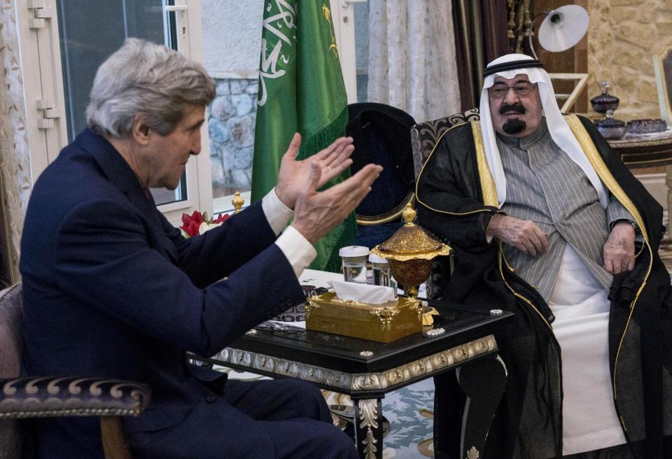 U.S. Secretary of State John Kerry, left, speaks with Saudi Arabia's King Abdullah before their meeting in Rawdat Khurayim, a secluded royal hunting retreat in Saudi Arabia, Sunday, Jan. 5, 2014. (AP Photo/Brendan Smialowski, Pool)