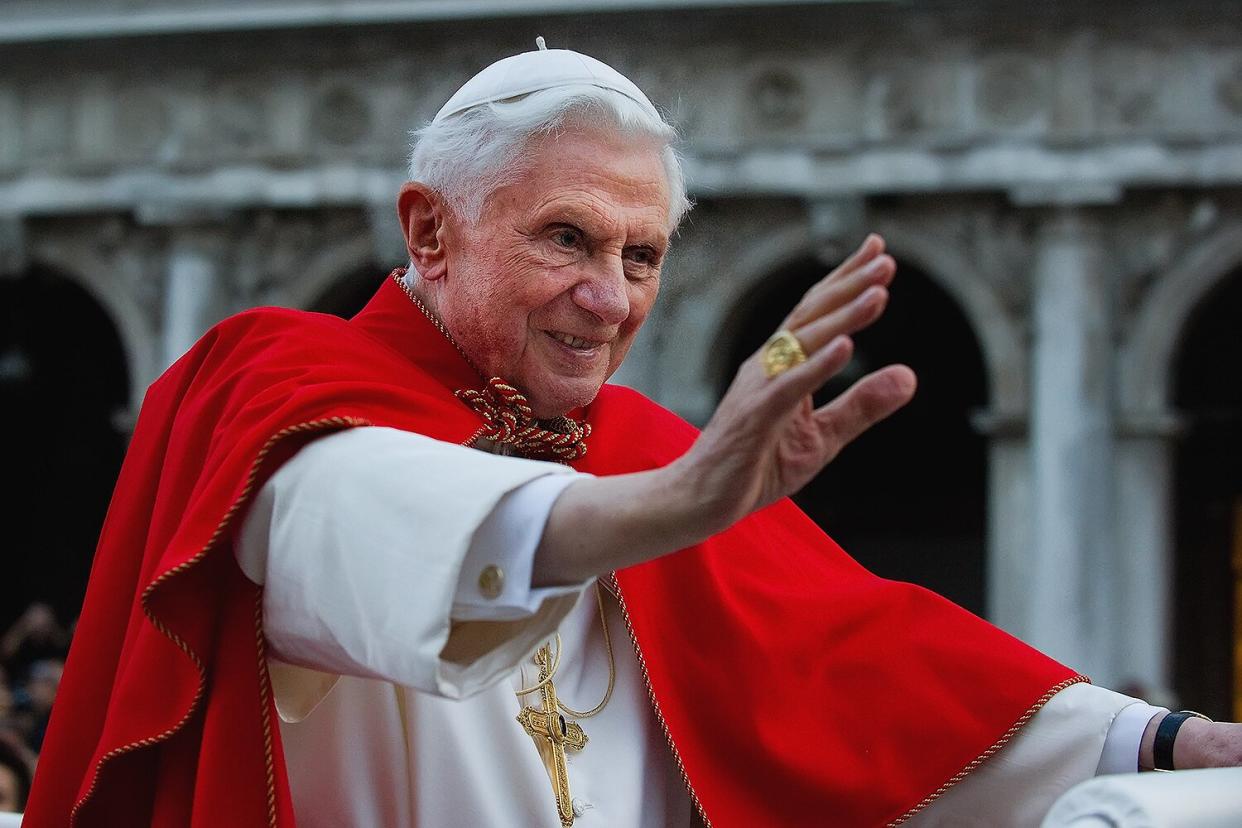 Pope Benedict XVI greets the crowd gathered in St Mark's Square while crossing the square on an electric car on May 7, 2011 in Venice, Italy.