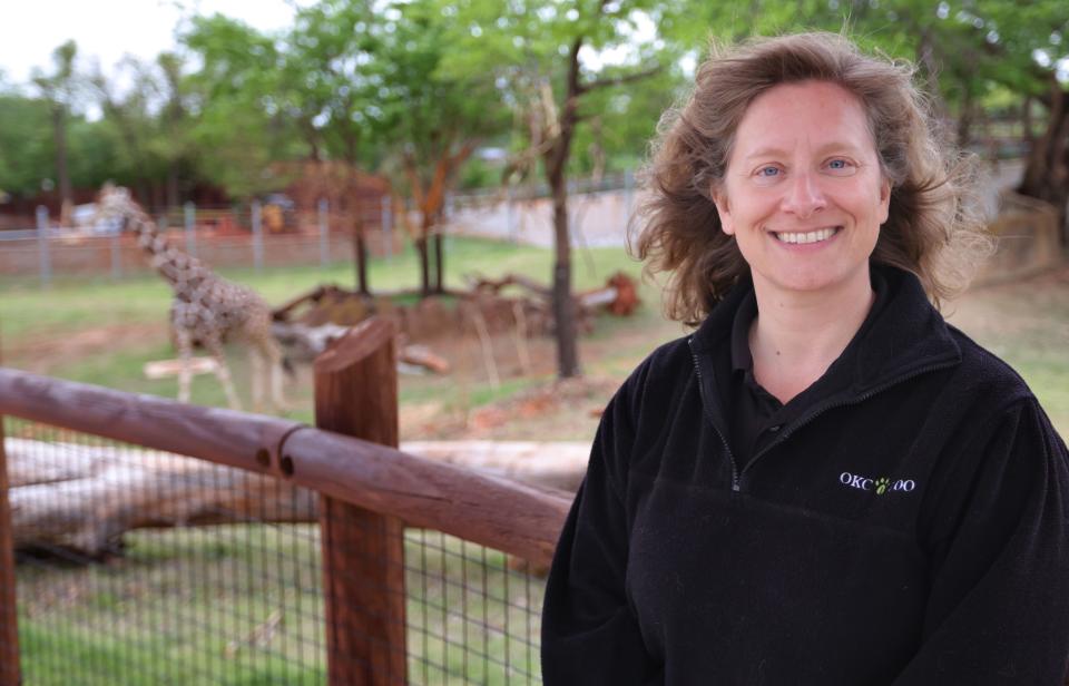 Jennifer D'Agostino, chief animal program officer, is pictured April 18 near the giraffe habitat at the Oklahoma City Zoo and Botanical Garden. "I want people to get excited about these animals and care about them so that they will do their part to help with conservation efforts, as well," she said.