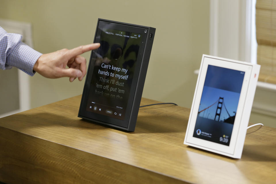 In this photo taken Tuesday, Sept. 17, 2019, product manager Bill Lee demonstrates the new Facebook Portal during an event in San Francisco. At right is the Portal Mini. Facebook is slashing the price and the size of the Portal, its screen and camera-equipped gadget for making video calls with friends and family as it attempts to get the device into more homes. A smaller version will now cost $129 and have an 8 inch display. A larger version will cost $179 and have a 10 inch display. (AP Photo/Eric Risberg)