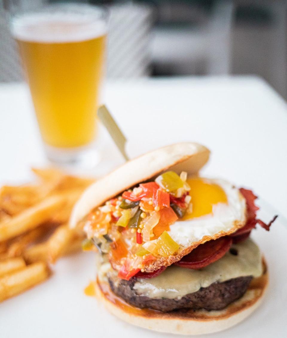 The Mooring's Gina Marie burger features a short rib brisket patty, hot Portuguese pepper relish, crispy chourico sausage and fontina cheese. A sunny side egg is included, and all of it is served on a toasted bolo, a Portuguese muffin.