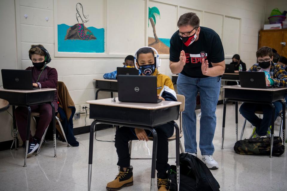 Fifth Grade Math Teacher Edwin Wade Arnold helps a student on the first day back to in-person learning at DuPont Taylor Middle School on Friday, Feb. 26, 2021 in Nashville, Tenn. 