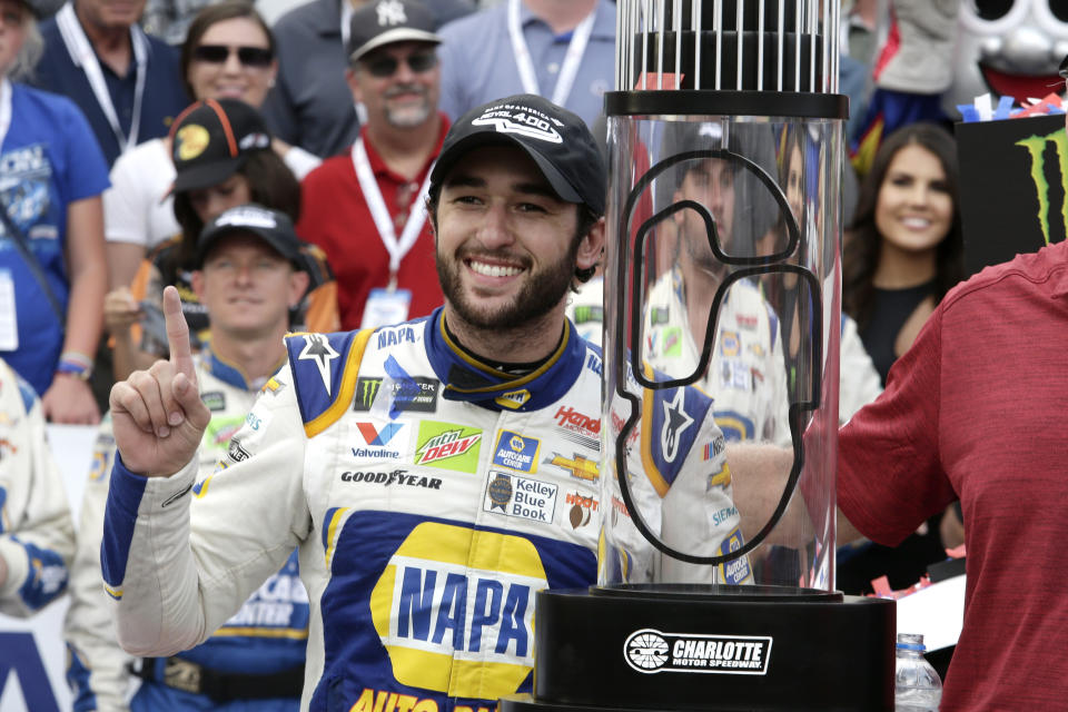 Chase Elliott poses with the trophy after winning the NASCAR Cup Series auto race at Charlotte Motor Speedway in Concord, N.C., Sunday, Sept. 29, 2019. (AP Photo/Wesley Broome)