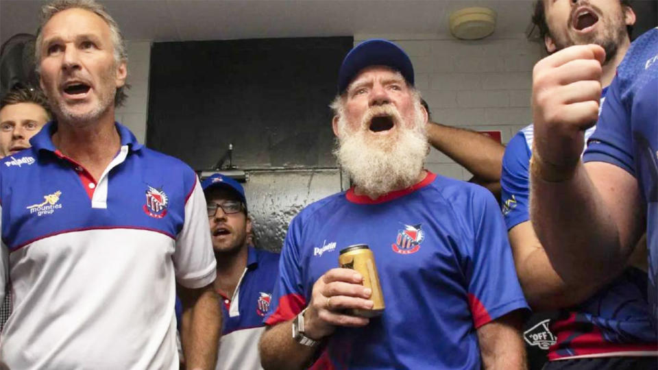 Club rugby icon Russel 'Rusty' Mackie is pictured holding a beer after a Manly Marlins game.