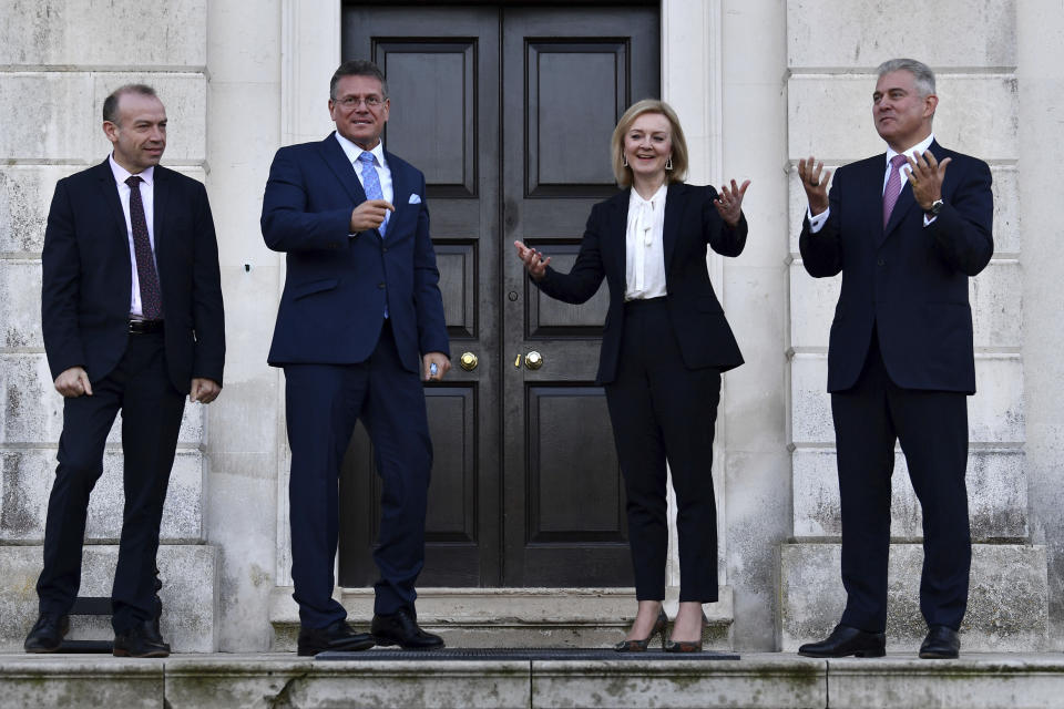 Foreign Secretary Liz Truss, second right, Minister of State for Europe Christopher Heaton-Harris, left, and Secretary of State for Northern Ireland Brandon Lewis, right, welcome EU post-Brexit negotiator Maros Sefcovic as he arrives for a meeting at Chevening in Kent, England, Thursday, Jan. 13, 2022. Top negotiators from Britain and the European Union are meeting in hope of resolving their a thorny dispute over Northern Ireland trade. (Ben Stanstall/Pool Photo via AP)