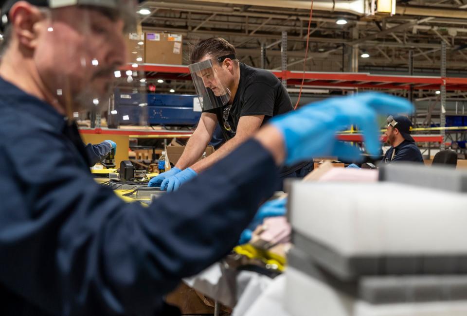 Michael Pandori (center) works on assembling protective face shields at Troy Manufacturing Design a Ford subsidiary in Plymouth on Friday, March 27, 2020. Ford, in cooperation with the UAW, will assemble more than 100,000 critically needed plastic face shields per week to help medical professionals, factory workers and store clerks.
 