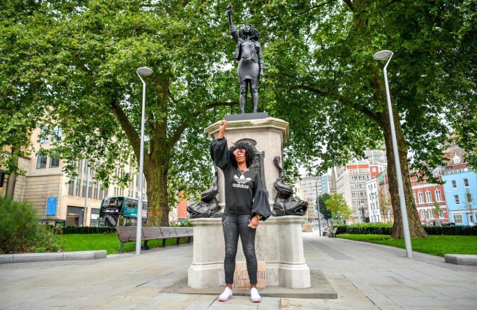 ‘I feel so proud’ ... Jen Reid poses in front of her black resin and steel statue.