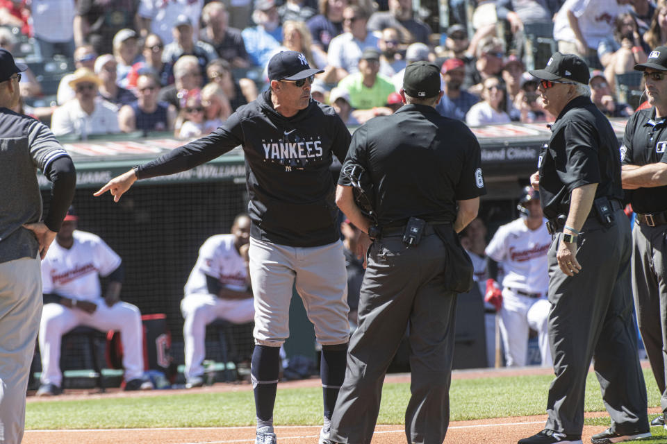 New York Yankees manager Aaron Boone argues a call with umpires during the first inning of a baseball game against the Cleveland Guardians in Cleveland, Wednesday April 12, 2023. Boone was ejected from the game. (AP Photo/Phil Long)