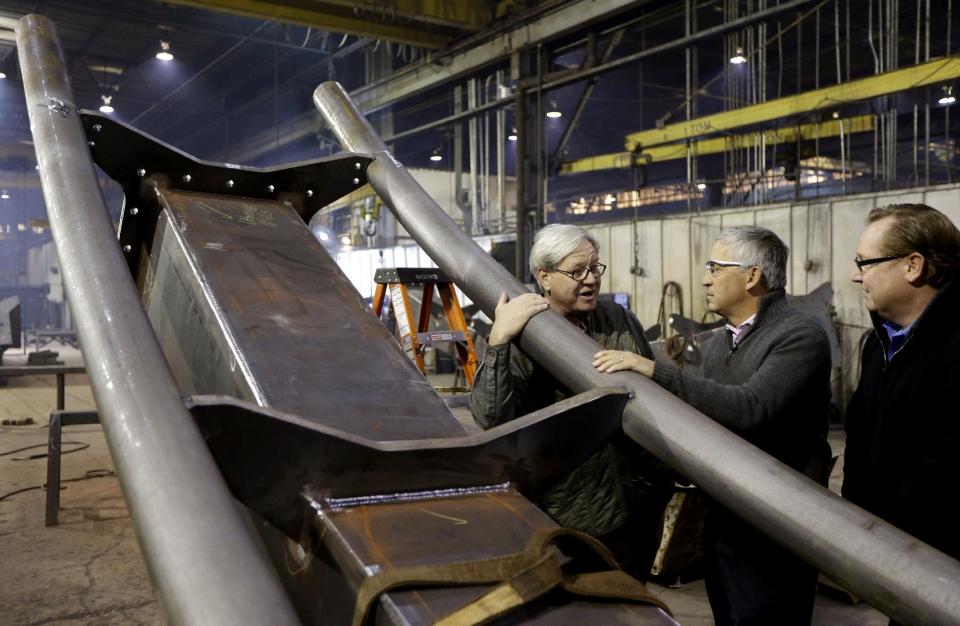 Cedar Fair CEO Matt Ouimet, center, tours the Clermont Steel Fabricating plant with plant representative Bob Mampe and Cedar Fair vice president of planning and design Rob Decker, right, Wednesday, Jan. 9, 2013, in Batavia, Ohio. Ouimet is encouraged about the company's future and the industry and believes one key is keeping people happy. He said the company's new dramatic roller coaster under construction in southwest Ohio will help achieve that goal. (AP Photo/Al Behrman)