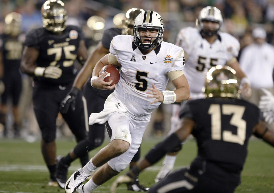 Central Florida quarterback Blake Bortles (5) dashes for a rushing touchdown as Baylor safety Terrell Burt (13) defends during the second half of the Fiesta Bowl NCAA college football game, Wednesday, Jan. 1, 2014, in Glendale, Ariz. (AP Photo/Rick Scuteri)