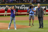 Former President George W. Bush, right, looks on as Andita Pollozani throws out the the first ceremonial pitch to recognize the 21st anniversary of Patriot Day before a baseball game between the Toronto Blue Jays and the Texas Rangers in Arlington, Texas, Sunday, Sept. 11, 2022. (AP Photo/LM Otero)