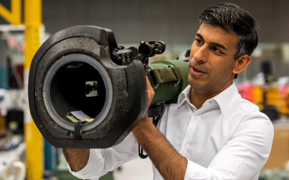 Rishi Sunak looks at an NLAW anti-tank missile launcher, supplied to Ukraine, as he visits the Thales Defence System plant in Belfast - Reuters