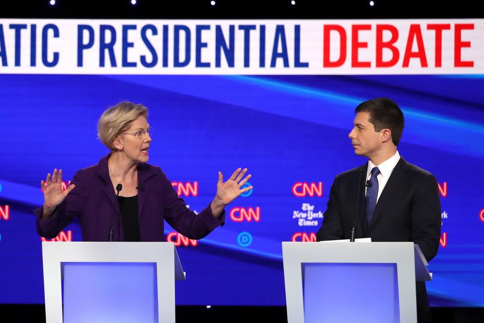 Sen. Elizabeth Warren, D-Mass., speaks to Pete Buttigieg the mayor of South Bend, Ind. during Democratic presidential primary debate at Otterbein University.