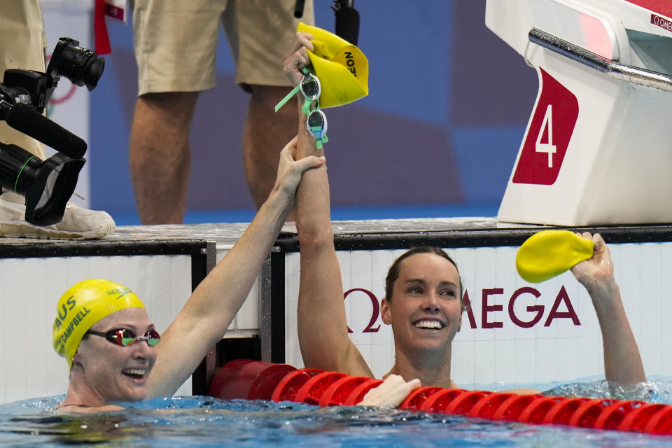 Emma Mckeon, of Australia, right, celebrates with teammate Cate Campbell after winning the women's 100-meter freestyle final at the 2020 Summer Olympics, Friday, July 30, 2021, in Tokyo, Japan. (AP Photo/Jae C. Hong)