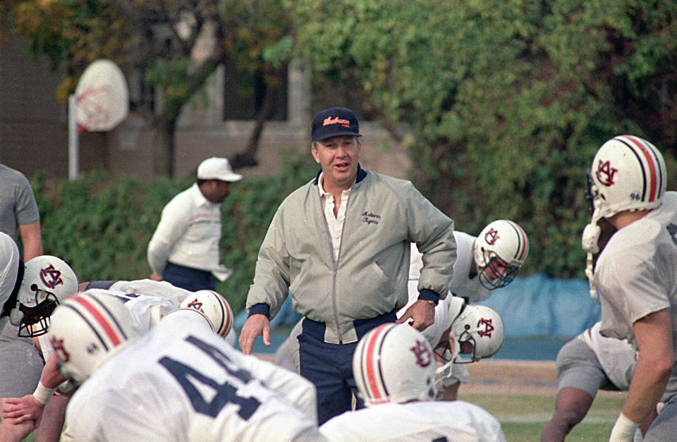 FILE - In this Dec. 27, 1988, file photo, Auburn NCAA college football coach Pat Dye walks through his players as they begin workouts in preparation for the Sugar Bowl in New Orleans. Former Auburn coach Pat Dye, who took over a downtrodden football program in 1981 and turned it into a Southeastern Conference power, has died. He was 80. Lee County Coroner Bill Harris said Dye passed away Monday, June 1, 2020, at the Compassus Bethany House in Auburn, Ala.(AP Photo/Bill Haber, FIle)