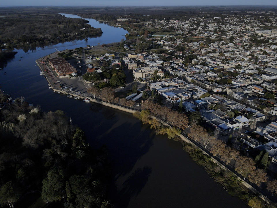 The Rio Gualeguaychu river runs through Gualeguaychu in the Entre Rios province of Argentina, a few kilometers from the Uruguayan border, Saturday, July 1, 2023. Free-spending Uruguayans have thrown an economic lifeline to struggling Argentine stores and shops but back in Uruguay businesses complain they now hardly have customers. (AP Photo/Natacha Pisarenko)