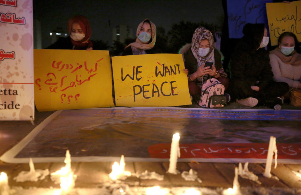 Members of a civil society hold a candle light vigil for coal mine workers killed by gunmen near the Machh coal field, in Islamabad, Pakistan, Wednesday, Jan. 6, 2021. Pakistan's minority Shiites continued their sit-in for a fourth straight day insisting they will bury their dead only when Prime Minister Imran Khan personally visits them to assure protection. (AP Photo/Anjum Naveed)