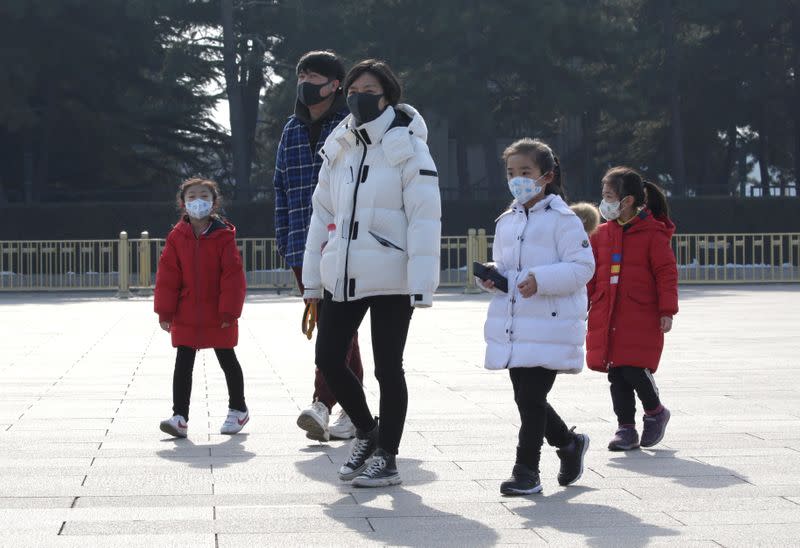 Tourists wearing masks visit Tiananmen Square in Beijing