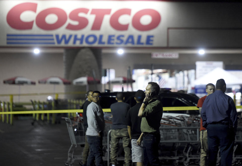 A Costco employee talks on the phone following a shooting within the wholesale outlet in Corona, Calif., Friday, June 14, 2019. A gunman opened fire inside the store during an argument, killing a man, wounding two other people and sparking a stampede of terrified shoppers before he was taken into custody, police said. The man involved in the argument was killed and two other people were wounded, Corona police Lt. Jeff Edwards said. (Will Lester/Inland Valley Daily Bulletin/SCNG via AP)