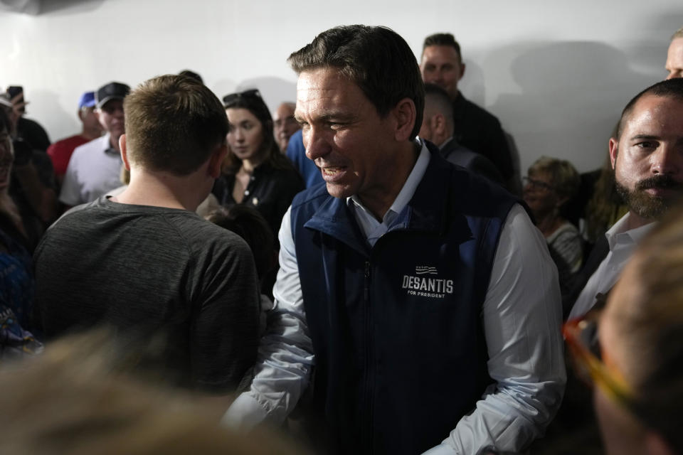 Republican presidential candidate Florida Gov. Ron DeSantis greets local residents during a meet and greet at the Hotel Charitone, Thursday, July 27, 2023, in Chariton, Iowa. / Credit: Charlie Neibergall / AP