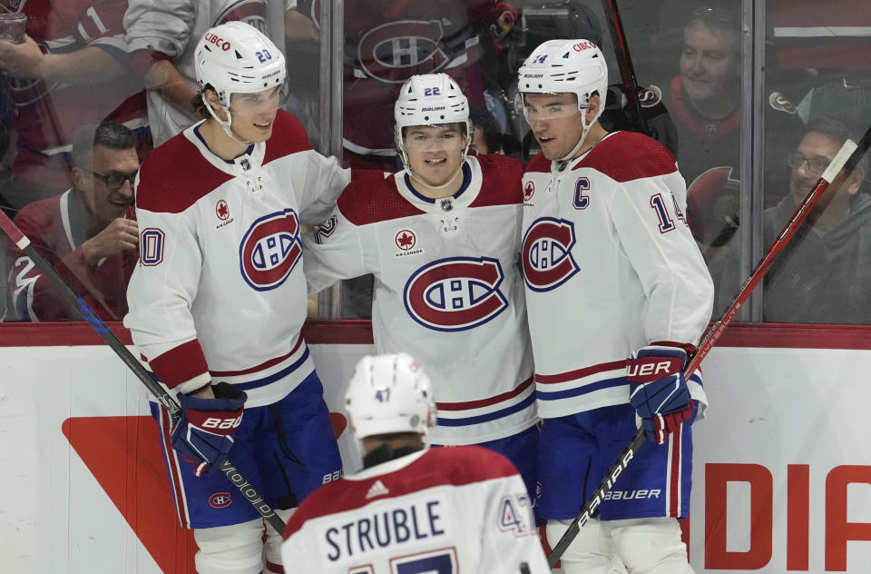 Montreal Canadiens right wing Cole Caufield (22) celebrates after a goal with teammates Juraj Slafkovsky (20), Nick Suzuki (14) and Jayden Struble during second-period NHL hockey game action in Ottawa, Ontario, Saturday, April 13, 2024. (Adrian Wyld/The Canadian Press via AP)