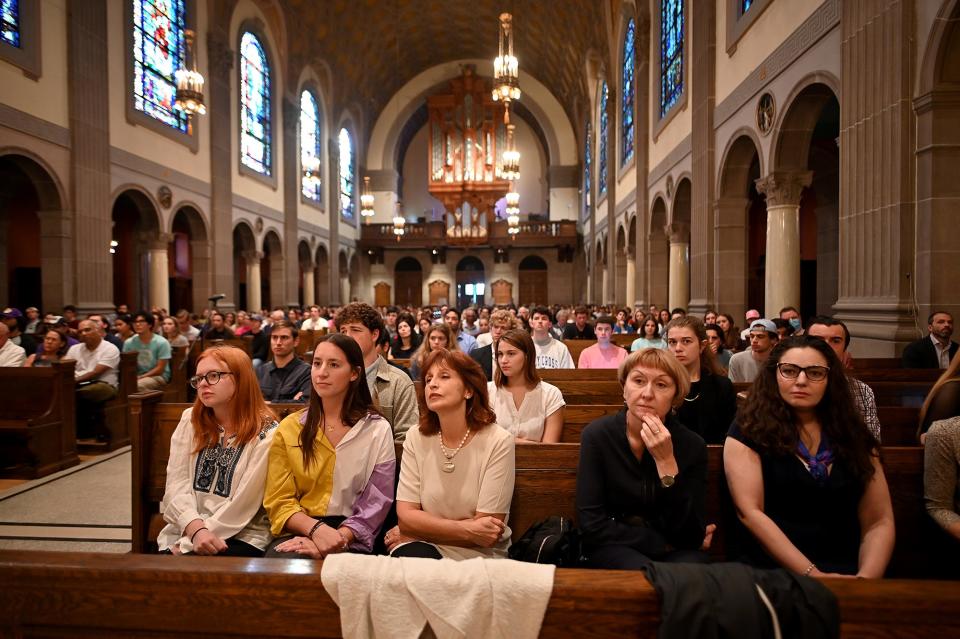 Faculty, students and guests listen as Russian journalist Dmitry Muratov speaks Thursday at the College of the Holy Cross' St. Joseph Memorial Chapel.