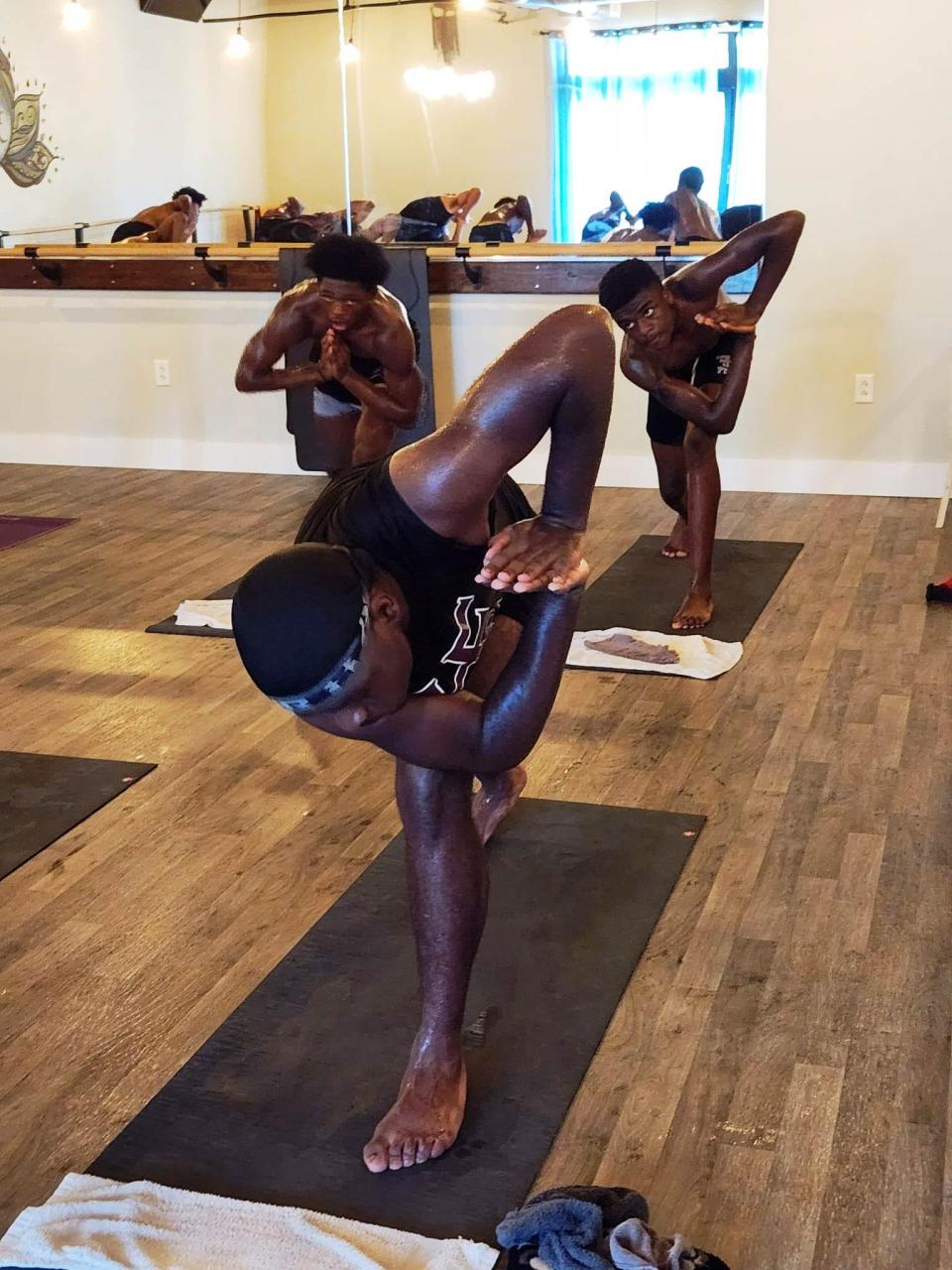 Players from the Peoria High School football team went through hot yoga sessions together at The Yoga Projekt in Peoria Heights as part of a reward for volunteering to help a charitable group, Make Your Marq.