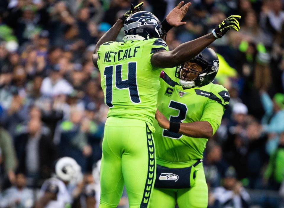 Seattle Seahawks quarterback Russell Wilson (3) and Seattle Seahawks wide receiver D.K. Metcalf (14) celebrate a touchdown during the second quarter. The Seattle Seahawks played the Los Angeles Rams in a NFL football game at CenturyLink Field in Seattle, Wash., on Thursday, Oct. 3, 2019.