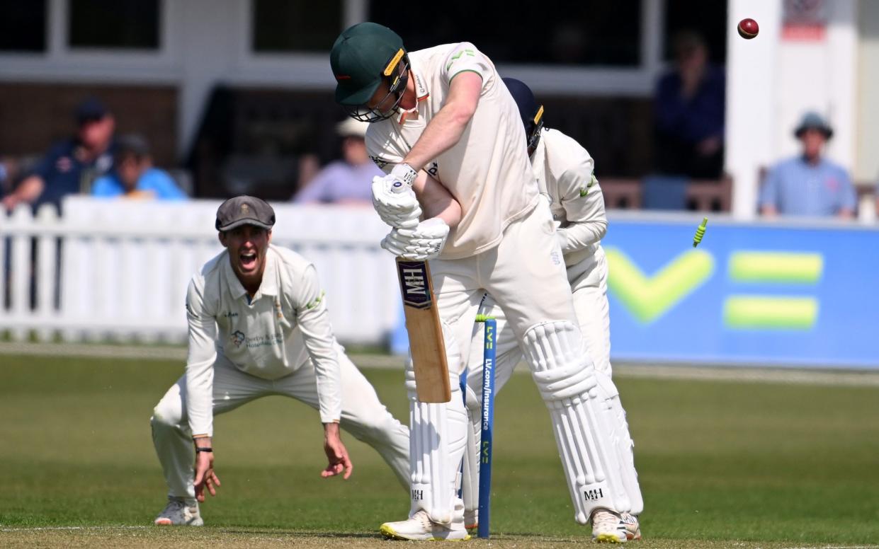 Louis Kimber of Leicestershire is bowled by Mattie McKiernan of Derbyshire during day one of the LV= Insurance County Championship match between Leicestershire and Derbyshire at Uptonsteel County Ground on April 21, 2022 in Leicester, England. - GETTY IMAGES