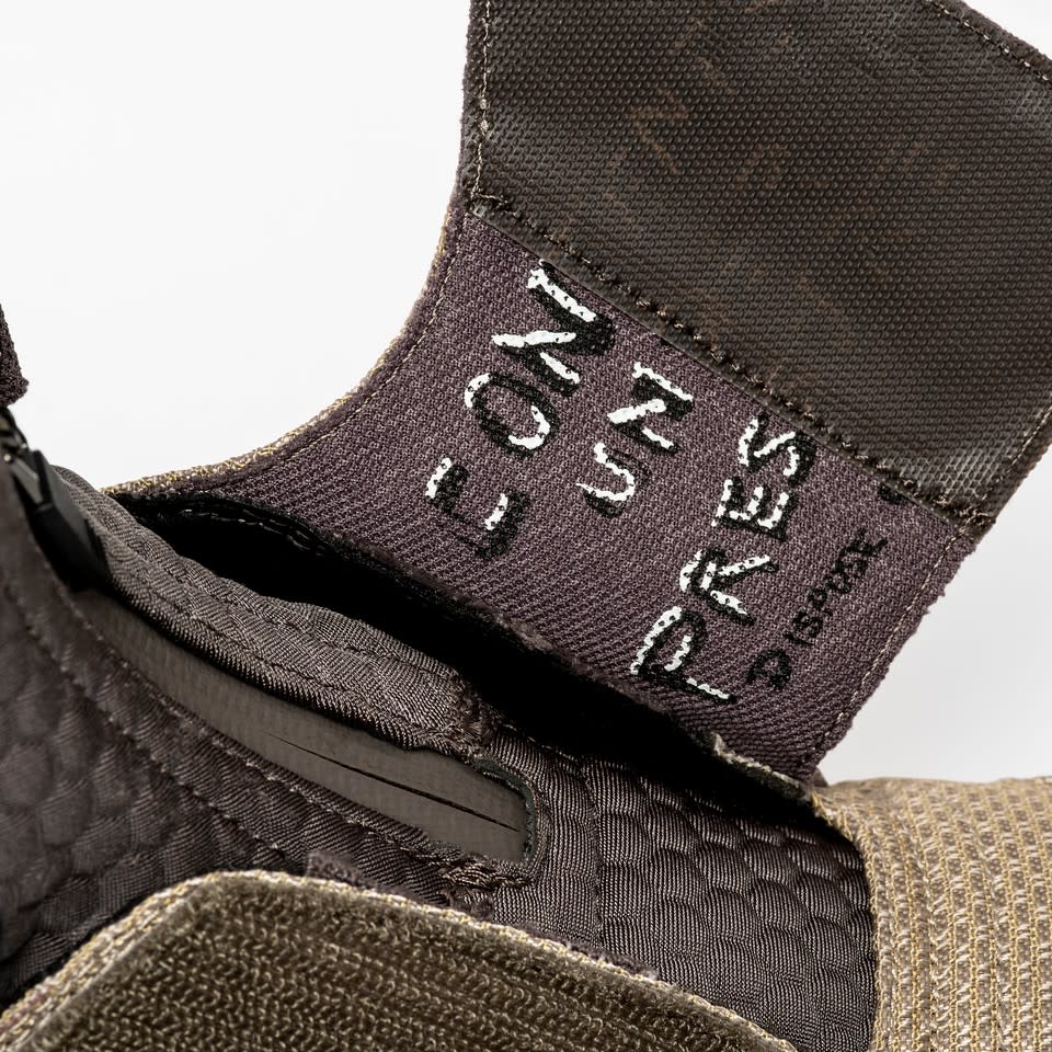 A 'Contents Under Pressure' message is also taken from Hudson's body armor (Photo: Reebok/Disney)