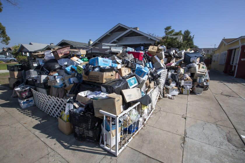 LOS ANGELES, CA - November 03 2021: A home in Koreatown is piled with belongings of a homeowner at 158 S. Harvard Blvd. in on Wednesday, Nov. 3, 2021 in Los Angeles, CA. (Brian van der Brug / Los Angeles Times)