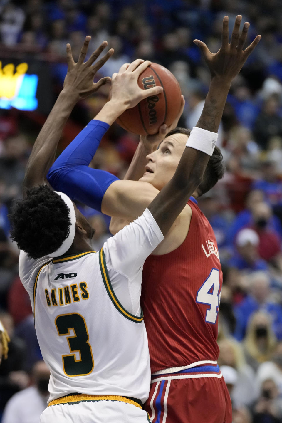 Kansas forward Mitch Lightfoot (44) shoots over George Mason guard Davonte Gaines (3) during the first half of an NCAA college basketball game in Lawrence, Kan., Saturday, Jan. 1 2022. (AP Photo/Orlin Wagner)