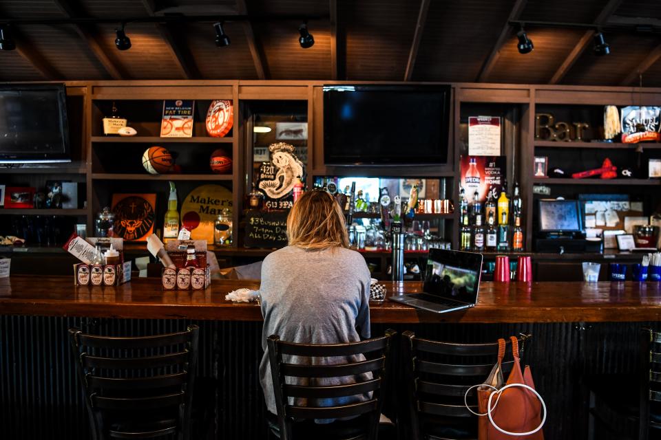 A customer sits at the bar as she eats in Moe's Original BBQ restaurant amid the coronavirus pandemic in Atlanta, Georgia on April 27, 2020. - Some Georgia restaurants reopened on April 27, 2020 for limited dine-in service as the state loosened more coronavirus restrictions. (Photo by CHANDAN KHANNA / AFP) (Photo by CHANDAN KHANNA/AFP via Getty Images)